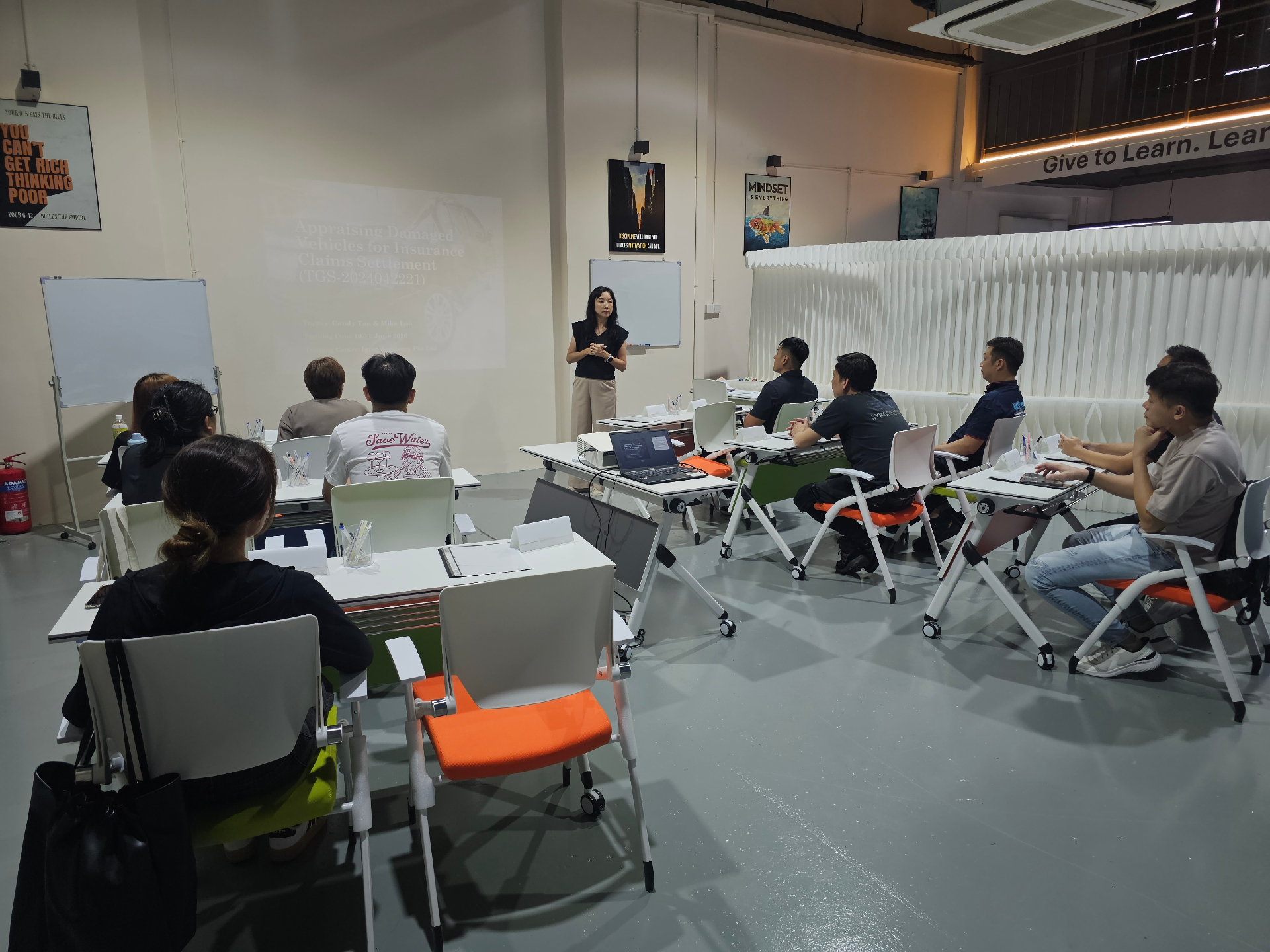 Insurance claims training session led by Igive in a classroom setting.