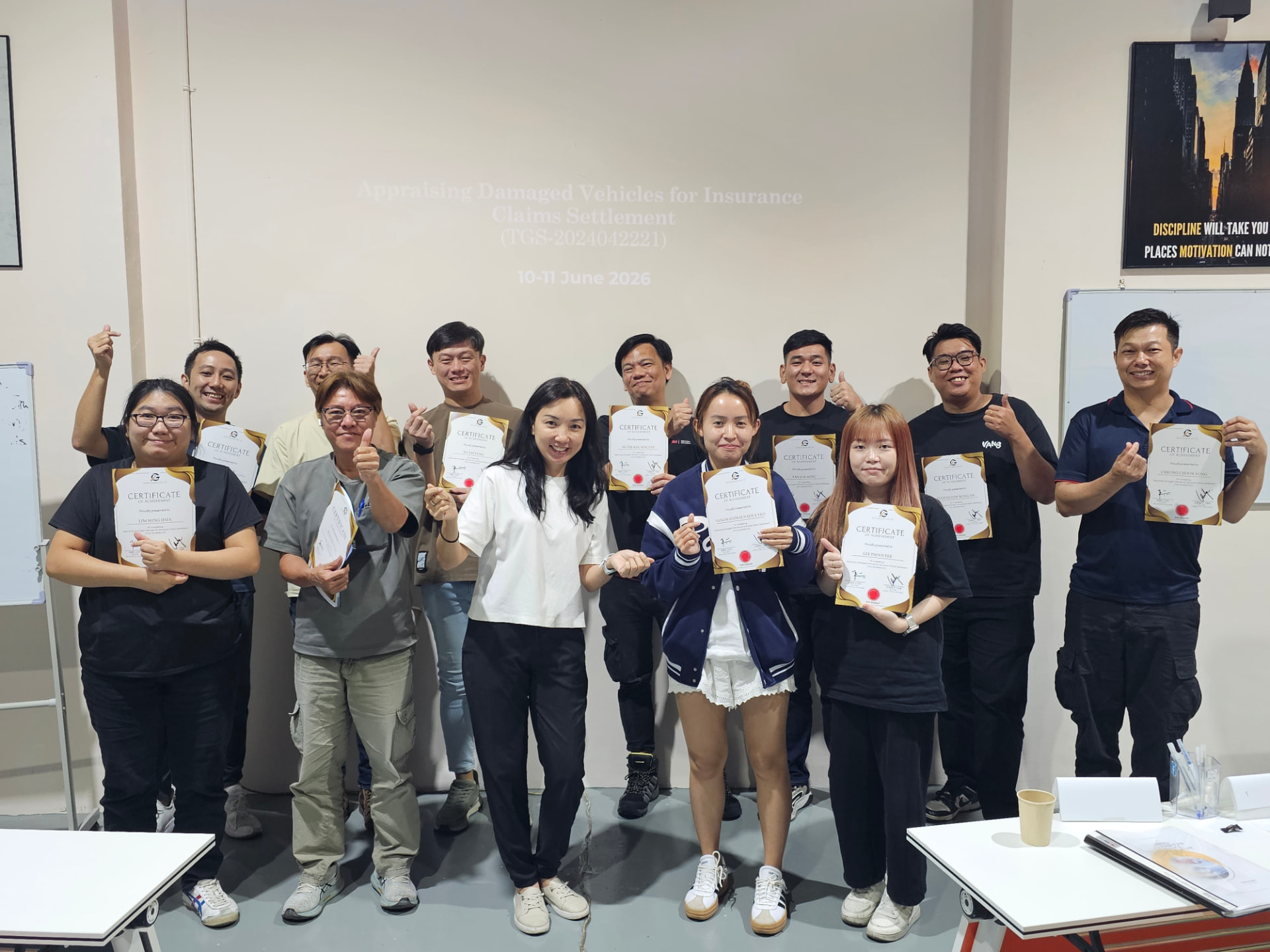Igive training graduates holding their Certificates of Achievement after completing the programme.
